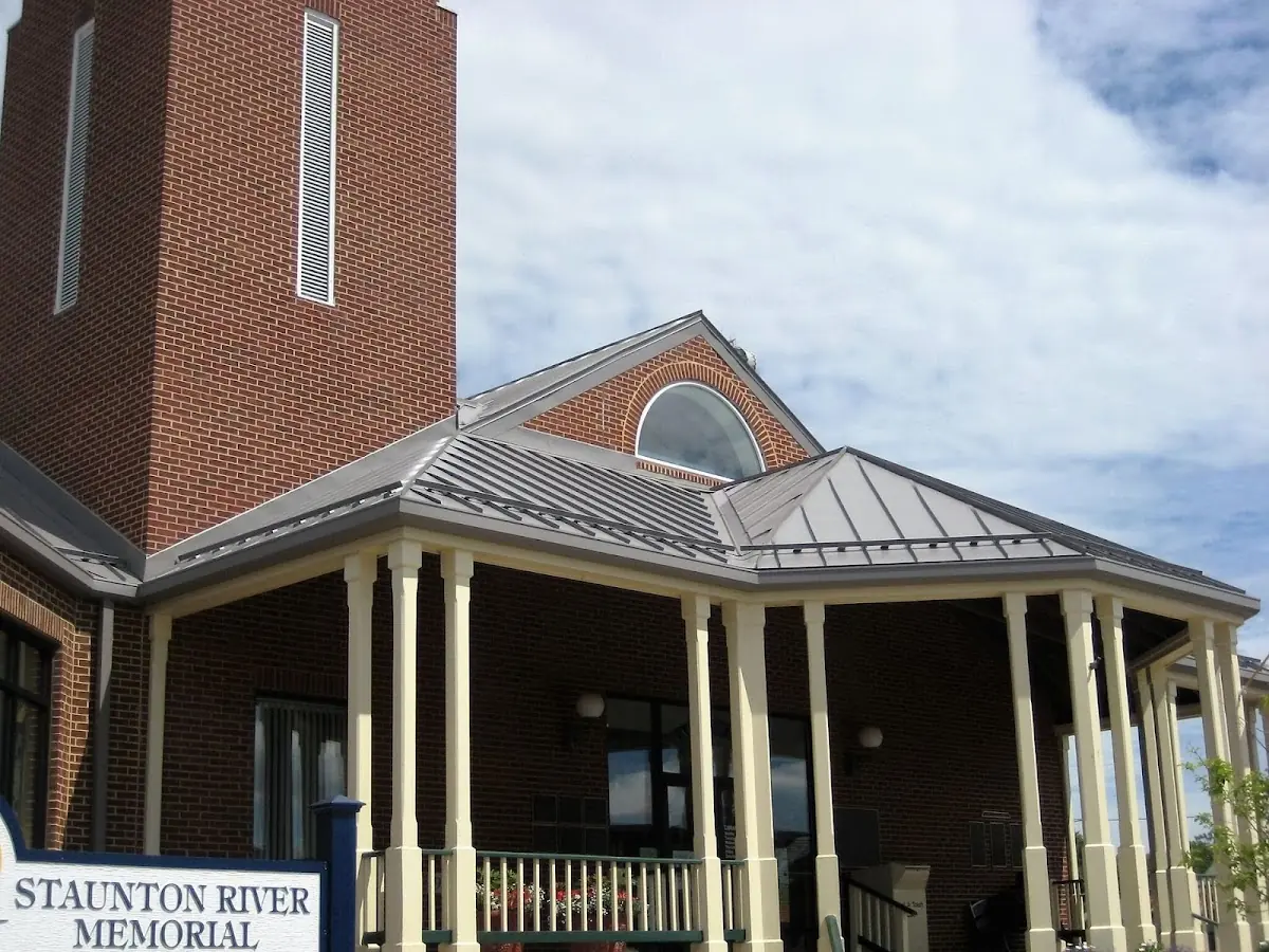 Skilled roofing craftsmen working on a residential roof in Amherst